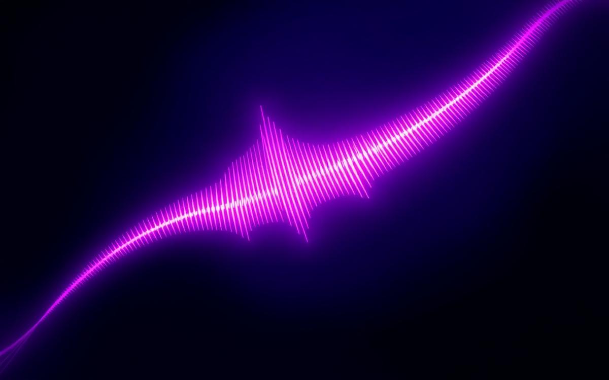 Glowing magenta audio waveform representing AI voice generation